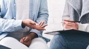 Social worker taking notes from trafficking survivor